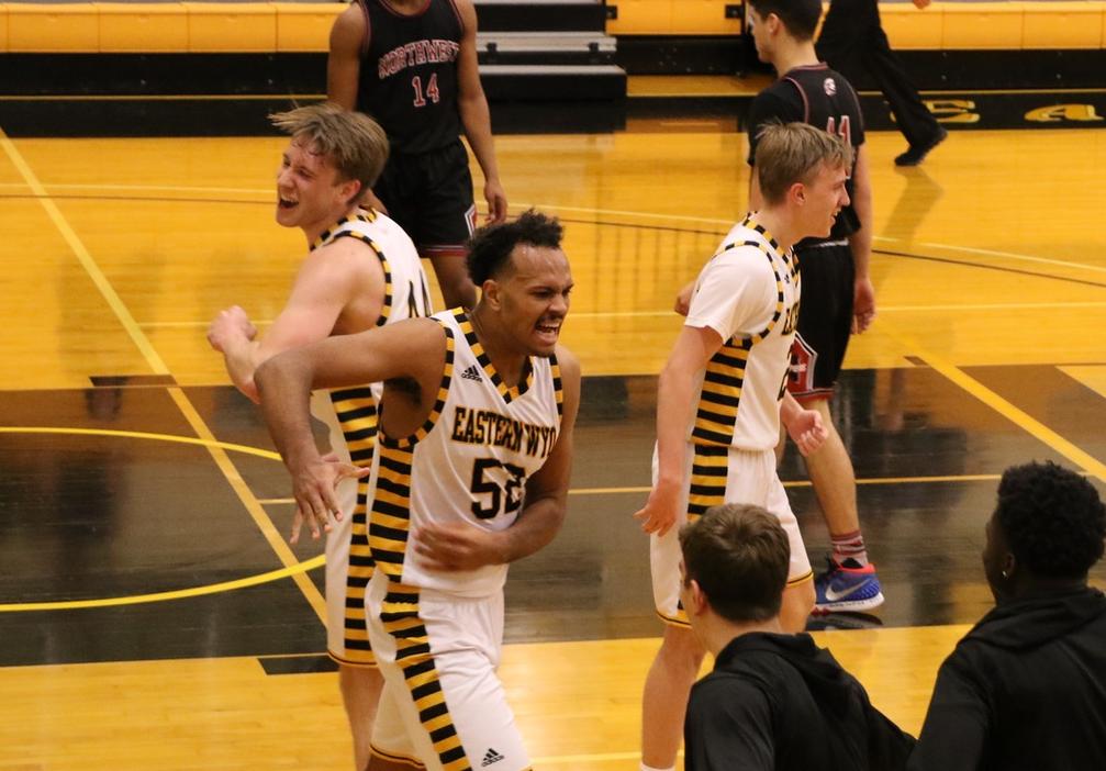 Sophomore Karl Drammeh (center) celebrates with sophomores David Höök (left) and Jonatan Arvidsson (right) near the end of EWC's 90-68 win against Northwest Saturday.